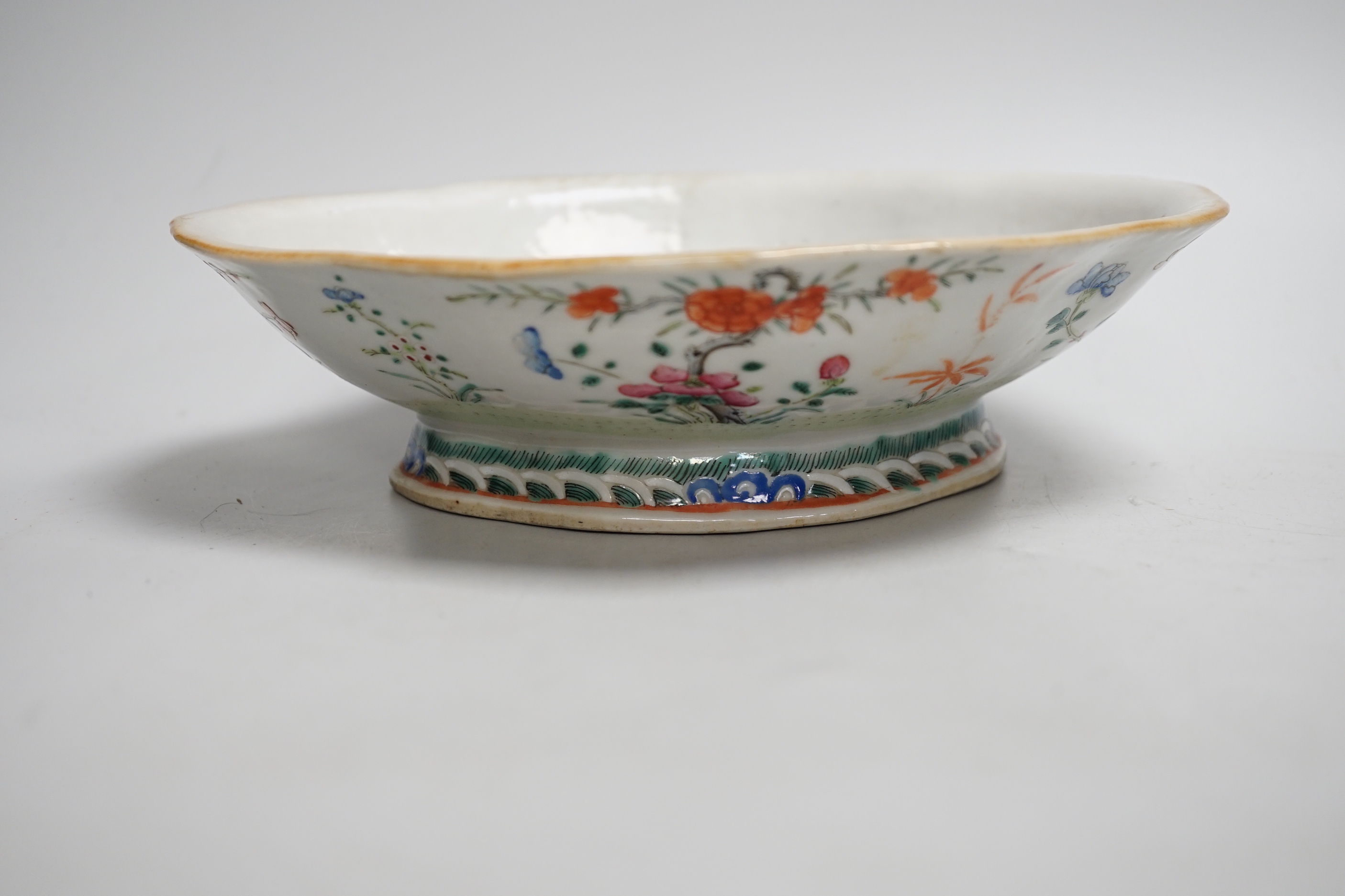 A 19th century Chinese blue and white ingot shaped dish and a famille rose footed dish, the largest 25cm wide (2)